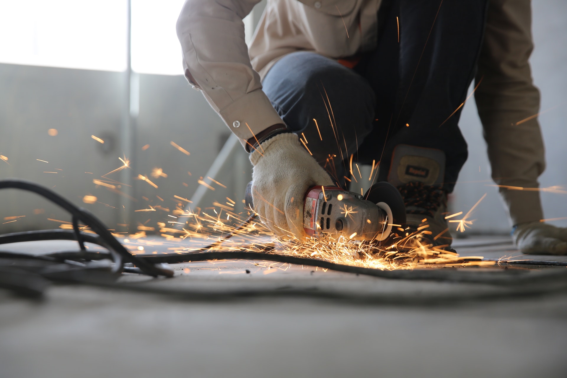 worker cutting metal